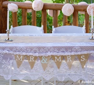 Coffee filter garland behind sweetheart table. mountainmodernlife.com