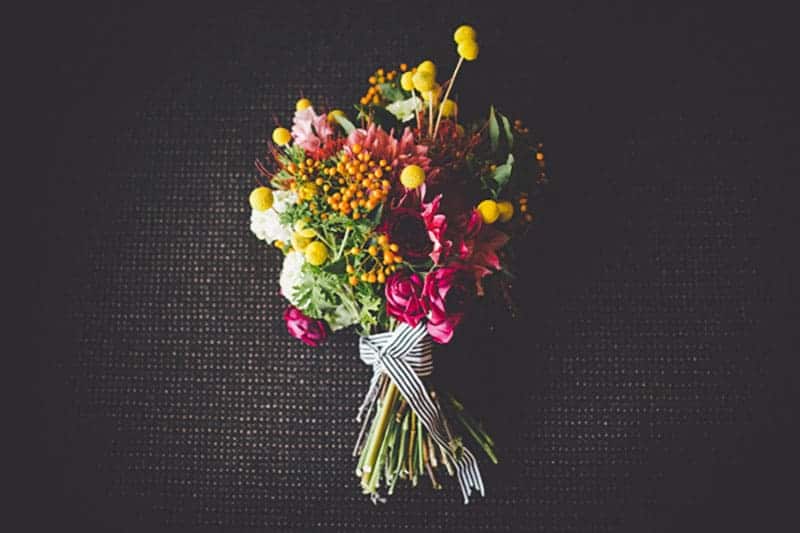 Planning a rustic or whimsical-inspired wedding? Check out this Craspedia wedding flower inspiration for ways to add this quirky flower to your decor.