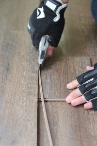 Cutting the edge off of floating flooring for slide out. MountainModernLife.com