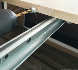 installing wooden dowels to connect table leaves