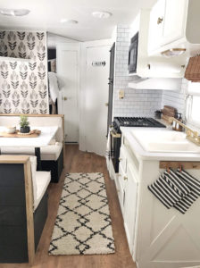 Tour this budget-friendly farmhouse camper that was transformed for $500 by Proverbs31Girl! Featured on MountainModernLife.com