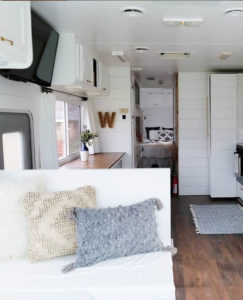 Tour this modern yet cozy renovated RV filled with lots of white, shiplap, and warm wood tones from @WilsonGrandAdventures! Featured on MountainModernLife.com