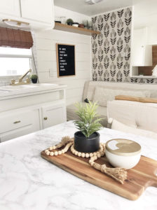 Tour this budget-friendly farmhouse camper that was transformed for $500 by Proverbs31Girl! Featured on MountainModernLife.com