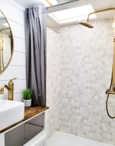 Tour this modern yet cozy renovated RV filled with lots of white, shiplap, and warm wood tones from @WilsonGrandAdventures! Featured on MountainModernLife.com