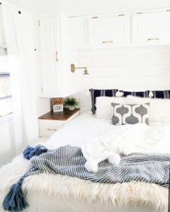 Tour this modern yet cozy renovated RV filled with lots of white, shiplap, and warm wood tones from @WilsonGrandAdventures! Featured on MountainModernLife.com