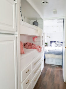 Tour this modern yet cozy renovated RV filled with lots of white, shiplap, and warm wood tones from @WilsonGrandAdventures! Featured on MountainModernLife.com