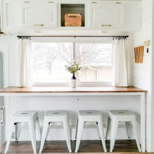 Tour this modern yet cozy renovated RV filled with lots of white, shiplap, and warm wood tones from @WilsonGrandAdventures! Featured on MountainModernLife.com