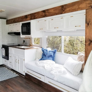 Tour this remodeled RV filled with lots of white, shiplap, and warm wood tones from @WilsonGrandAdventures! Featured on MountainModernLife.com