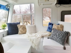 Tour this modern yet cozy renovated RV filled with lots of white, shiplap, and warm wood tones from @WilsonGrandAdventures! Featured on MountainModernLife.com