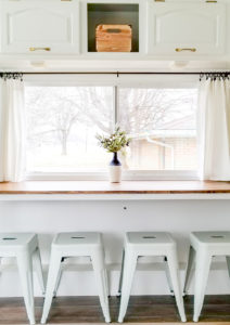 Tour this remodeled RV filled with lots of white, shiplap, and warm wood tones from @WilsonGrandAdventures! Featured on MountainModernLife.com