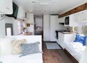 Tour this modern yet cozy renovated RV filled with lots of white, shiplap, and warm wood tones from @WilsonGrandAdventures! Featured on MountainModernLife.com