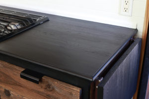 Considering adding black kitchen countertops to your home? Come see how we updated butcher block countertops for a rustic modern vibe in our RV. MountainModernLife.com