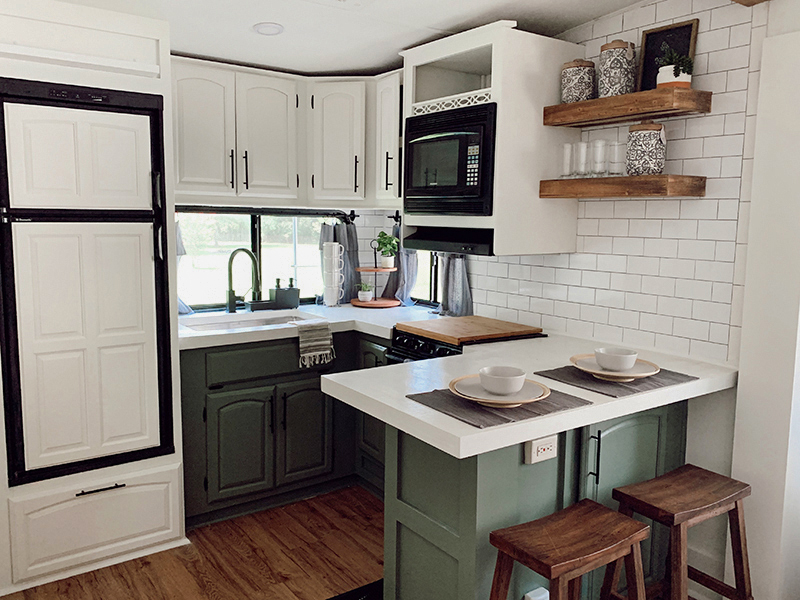 This remodeled RV kitchen has green cabinets and white concrete counters. Featuring @karleeandweston on MountainModernLife.com