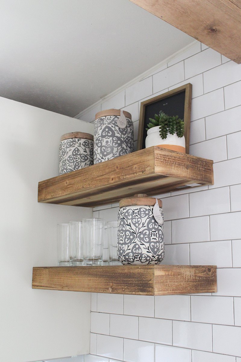 This remodeled RV kitchen has floating shelves. Featuring @karleeandwestonh on MountainModernLife.com