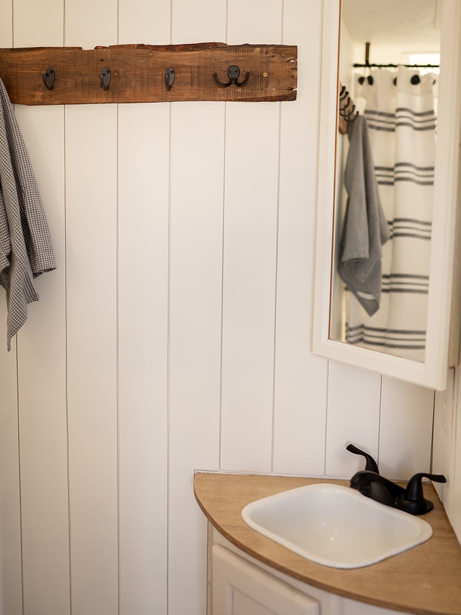 This vintage-country camper renovation has the coziest bed nook