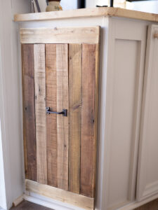 rustic reclaimed wood cabinet inside camper