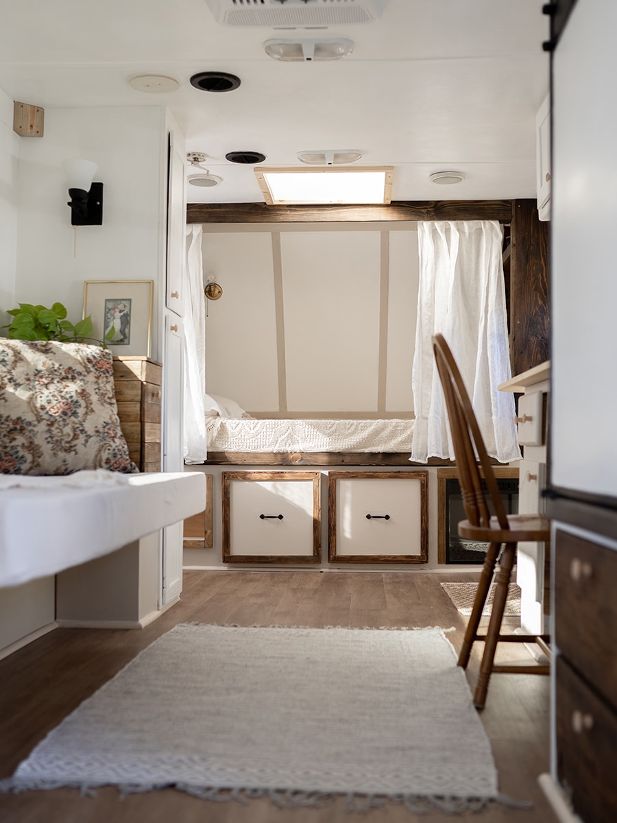 This vintage-country camper renovation has the coziest bed nook