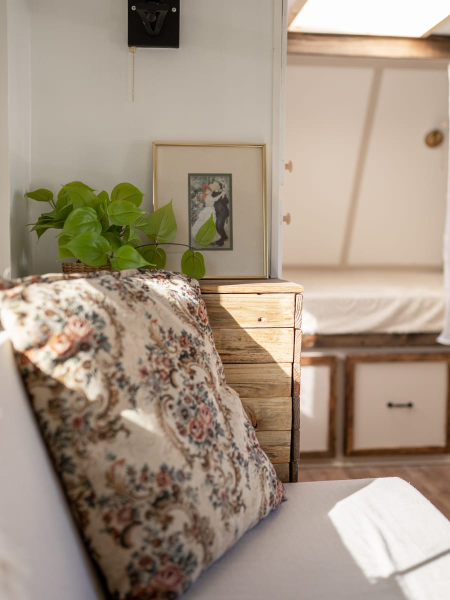 This vintage-country camper renovation has the coziest bed nook