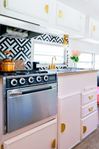 camper oven and pink kitchen cabinets