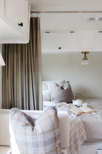 cozy camper interior with plaid pillows