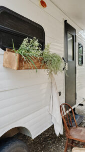 painted camper exterior with window flower boxes