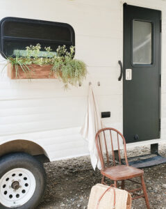 painted camper exterior with window boxes