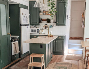 toy hauler with green kitchen cabinets